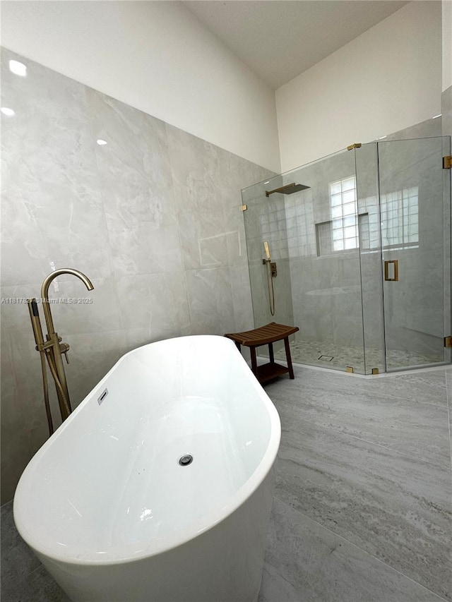 7020 Demedici Cir, Delray Beach, FL 33446 - full bathroom featuring a shower stall, tile walls, and a soaking tub