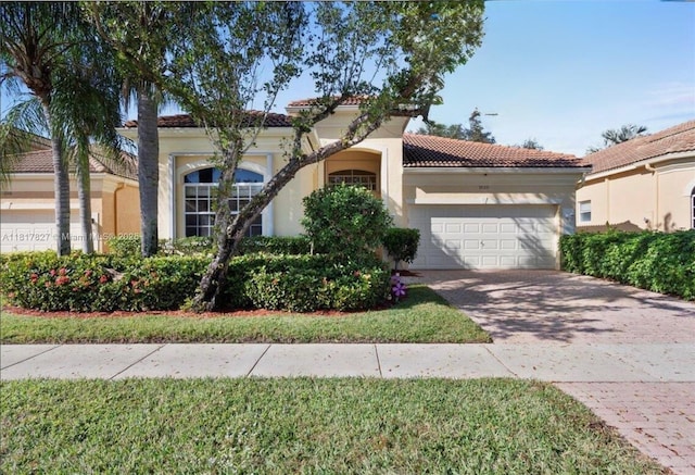 7020 Demedici Cir, Delray Beach, FL 33446 - mediterranean / spanish home with an attached garage, decorative driveway, a tiled roof, and stucco siding