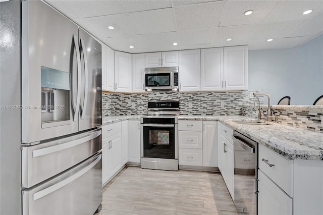 1449 NW 122nd Ter, Pembroke Pines, FL 33026 - kitchen featuring stainless steel appliances, white cabinets, backsplash, recessed lighting, and a paneled ceiling