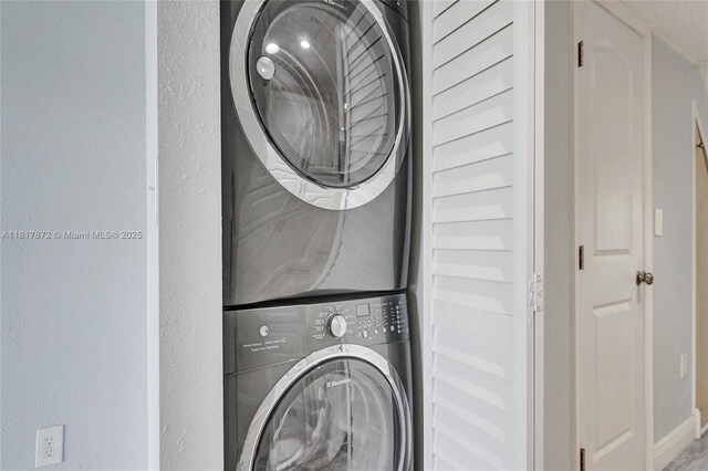 1449 NW 122nd Ter, Pembroke Pines, FL 33026 - laundry area featuring stacked washing machine and dryer and baseboards