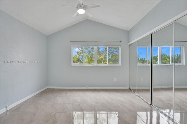 1449 NW 122nd Ter, Pembroke Pines, FL 33026 - unfurnished bedroom with multiple windows, vaulted ceiling, a ceiling fan, and a closet