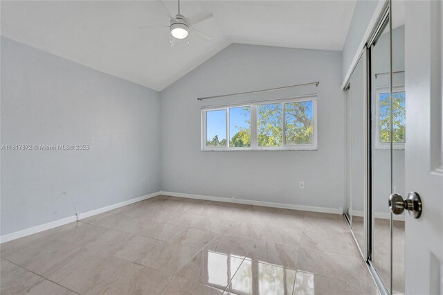 1449 NW 122nd Ter, Pembroke Pines, FL 33026 - unfurnished bedroom with a closet, multiple windows, vaulted ceiling, and a ceiling fan