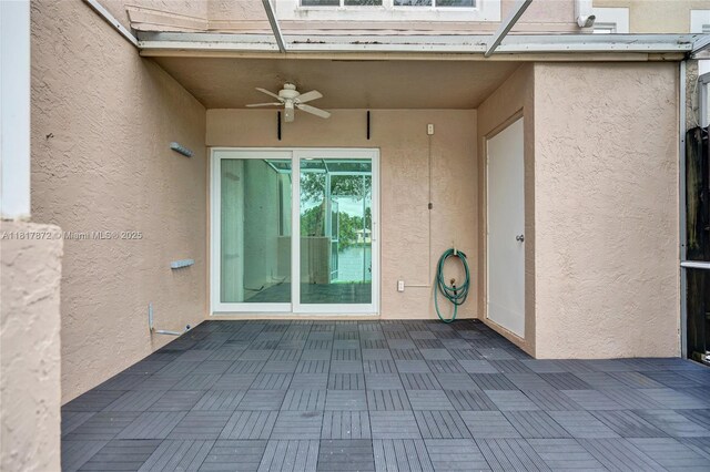 1449 NW 122nd Ter, Pembroke Pines, FL 33026 - view of exterior entry with a ceiling fan, stucco siding, and a patio area