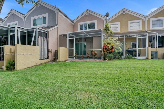 1449 NW 122nd Ter, Pembroke Pines, FL 33026 - rear view of property with stucco siding and a lawn