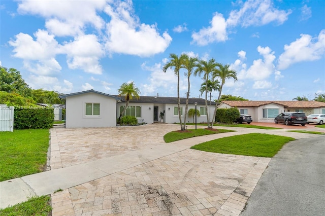 10223 SW 17th St, Miami, FL 33165 - ranch-style home with stucco siding, decorative driveway, and a front yard