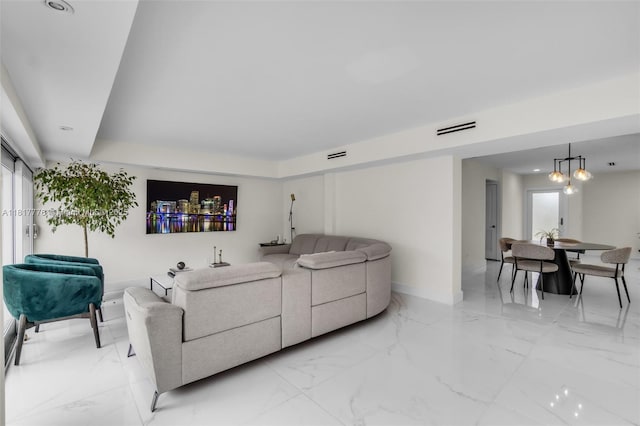 10223 SW 17th St, Miami, FL 33165 - living room featuring light marble finish floors, a chandelier, and baseboards
