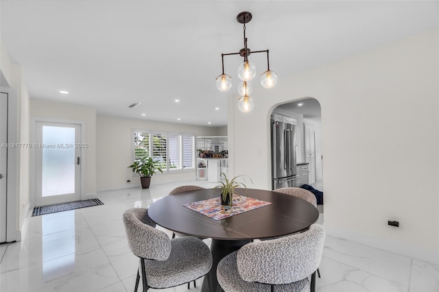 10223 SW 17th St, Miami, FL 33165 - dining space with light marble finish flooring, arched walkways, baseboards, and recessed lighting