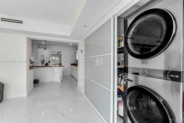 10223 SW 17th St, Miami, FL 33165 - washroom with stacked washing machine and dryer, baseboards, light marble finish floors, and recessed lighting