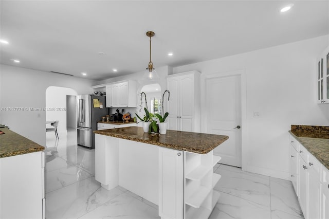 10223 SW 17th St, Miami, FL 33165 - kitchen with freestanding refrigerator, arched walkways, open shelves, recessed lighting, and a kitchen island