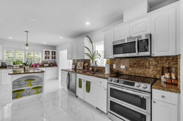 10223 SW 17th St, Miami, FL 33165 - kitchen with stainless steel appliances, a sink, white cabinetry, tasteful backsplash, and recessed lighting