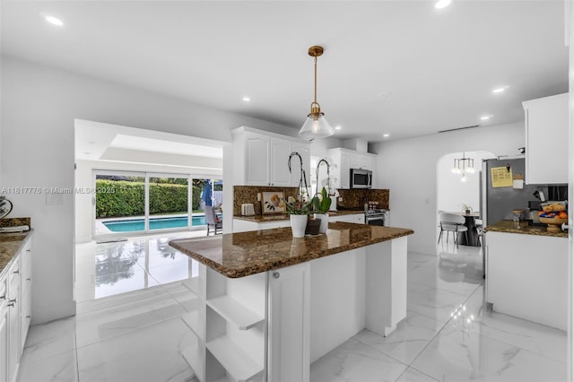 10223 SW 17th St, Miami, FL 33165 - kitchen featuring stainless steel appliances, tasteful backsplash, light marble finish flooring, white cabinets, and recessed lighting