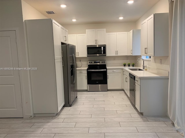 1041 SE 23rd Ter, Homestead, FL 33035 - kitchen featuring stainless steel appliances, wood tiled floors, light countertops, and recessed lighting