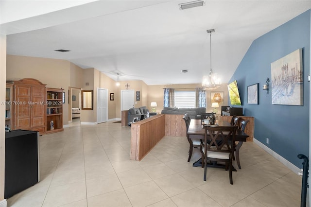 13317 NW 8th Ct, Sunrise, FL 33325 - dining room featuring vaulted ceiling, light tile patterned floors, baseboards, and a chandelier