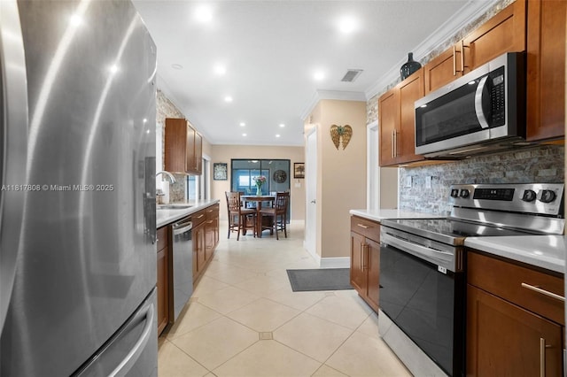 13317 NW 8th Ct, Sunrise, FL 33325 - kitchen featuring appliances with stainless steel finishes, ornamental molding, tasteful backsplash, light countertops, and a sink