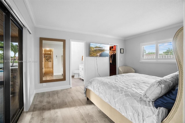 13317 NW 8th Ct, Sunrise, FL 33325 - bedroom featuring wood finished floors, crown molding, connected bathroom, a spacious closet, and baseboards