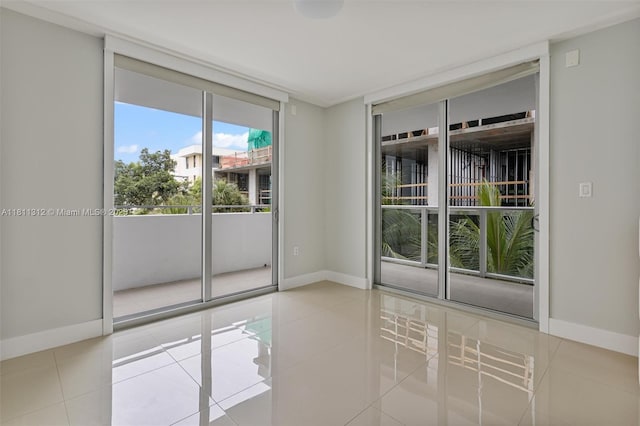 1150 101st St Unit 303, Bay Harbor Islands, FL 33154 - empty room featuring tile patterned flooring and expansive windows