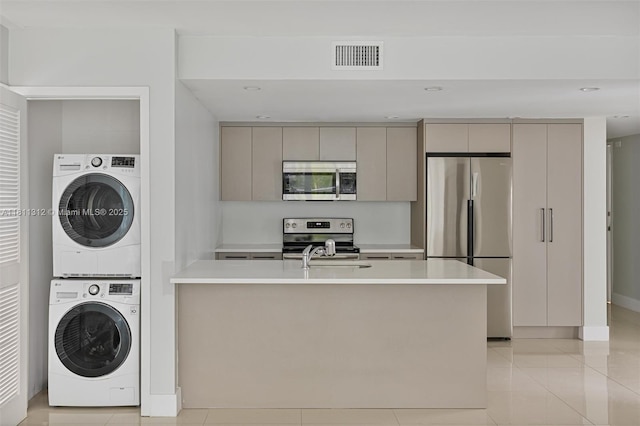 1150 101st St Unit 303, Bay Harbor Islands, FL 33154 - washroom featuring stacked washing machine and dryer, light tile patterned flooring, and recessed lighting