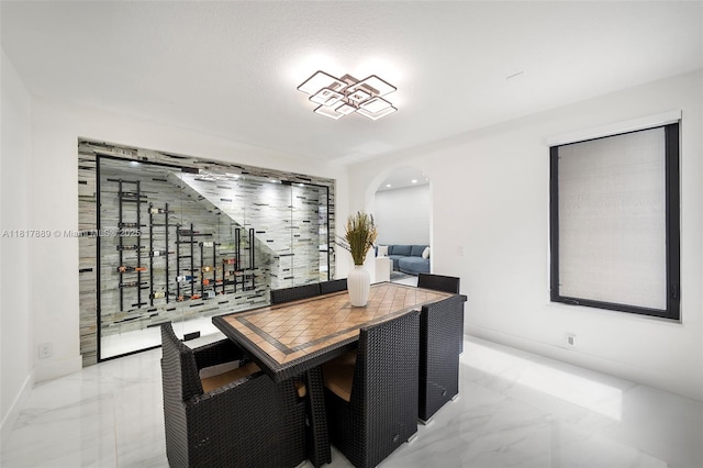 3461 SW 145th Ave, Miramar, FL 33027 - wine area featuring marble tiled flooring, baseboards, and arched walkways