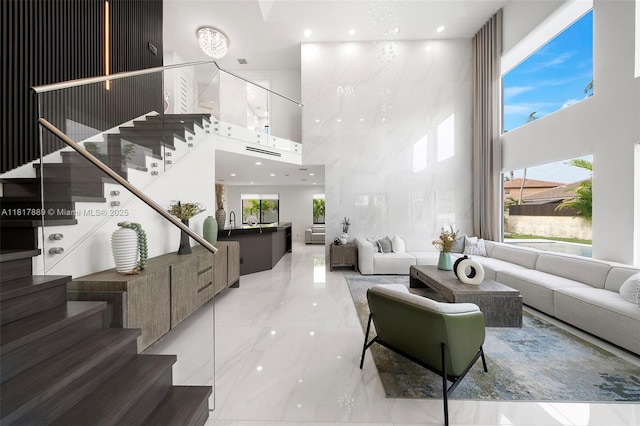 3461 SW 145th Ave, Miramar, FL 33027 - living room featuring a towering ceiling, stairway, healthy amount of natural light, marble tiled floors, and recessed lighting