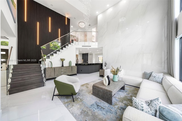 3461 SW 145th Ave, Miramar, FL 33027 - living area featuring stairway, a towering ceiling, marble tiled floors, recessed lighting, and plenty of natural light