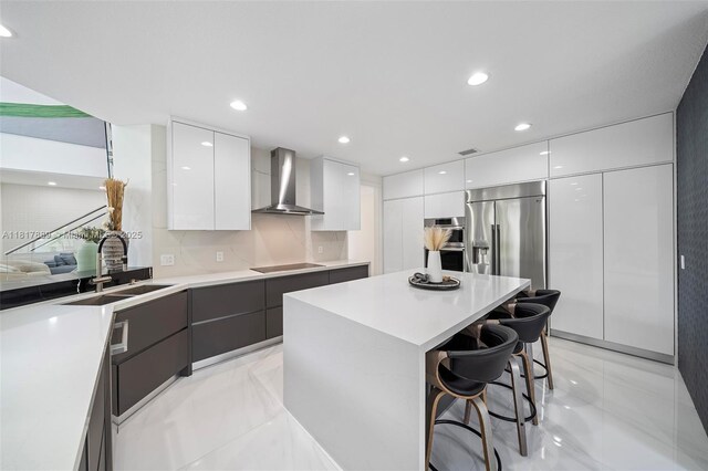 3461 SW 145th Ave, Miramar, FL 33027 - kitchen with modern cabinets, wall chimney exhaust hood, a sink, stainless steel fridge, and recessed lighting