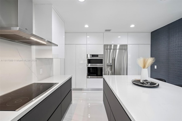 3461 SW 145th Ave, Miramar, FL 33027 - kitchen featuring wall chimney exhaust hood, modern cabinets, appliances with stainless steel finishes, white cabinets, and light countertops