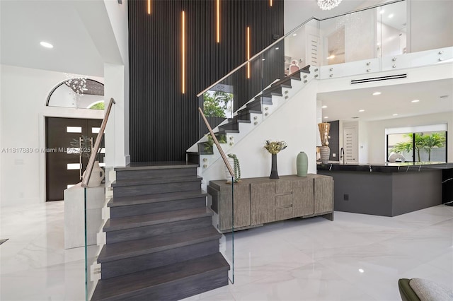 3461 SW 145th Ave, Miramar, FL 33027 - staircase featuring a high ceiling, marble tiled floors, and recessed lighting