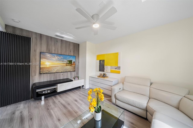 3461 SW 145th Ave, Miramar, FL 33027 - living area featuring wood finished floors, a ceiling fan, wood walls, and an accent wall