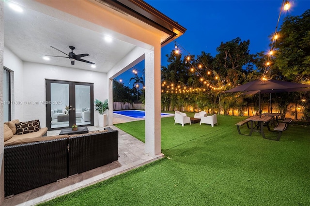 3461 SW 145th Ave, Miramar, FL 33027 - yard at twilight with outdoor lounge area, ceiling fan, a patio area, and french doors