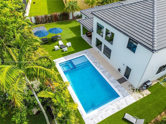 3461 SW 145th Ave, Miramar, FL 33027 - view of pool with a pool with connected hot tub, a yard, and a patio
