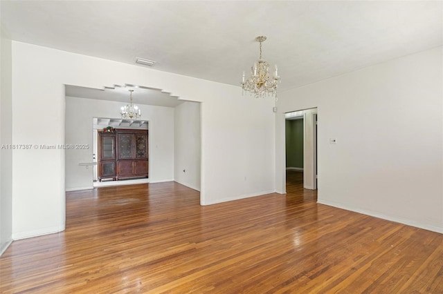3241 SW 20th St, Miami, FL 33145 - unfurnished room featuring a chandelier, wood finished floors, and baseboards