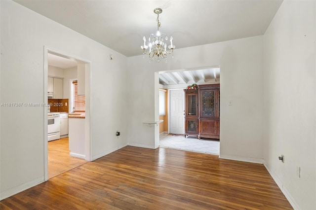 3241 SW 20th St, Miami, FL 33145 - spare room featuring light wood-type flooring, a chandelier, and baseboards