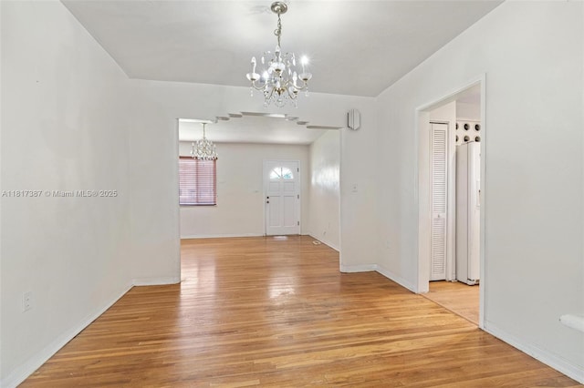 3241 SW 20th St, Miami, FL 33145 - unfurnished dining area with a chandelier, light wood-style flooring, and baseboards