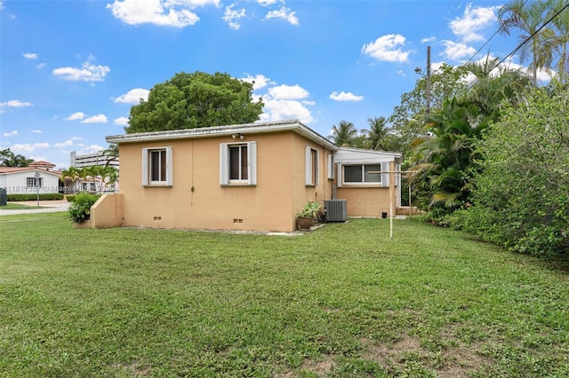 3241 SW 20th St, Miami, FL 33145 - view of side of property featuring crawl space, stucco siding, a lawn, and central AC