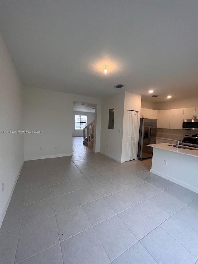 12945 SW 232nd Ln, Homestead, FL 33032 - unfurnished living room featuring electric panel, light tile patterned floors, stairway, baseboards, and recessed lighting