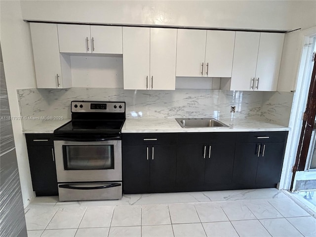 3072 SW 16th St, Miami, FL 33145 - kitchen with stainless steel electric stove, a sink, white cabinetry, and dark cabinets