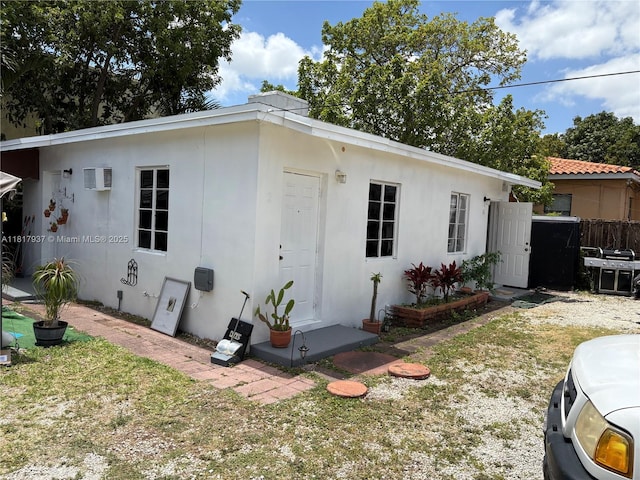 3072 SW 16th St, Miami, FL 33145 - view of property exterior featuring a wall mounted air conditioner and stucco siding