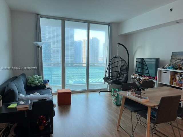 950 Brickell Bay Dr Unit 1608, Miami, FL 33131 - living room featuring plenty of natural light, floor to ceiling windows, wood finished floors, and a desk