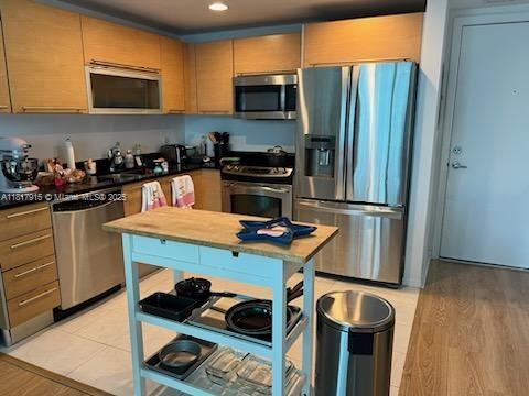 950 Brickell Bay Dr Unit 1608, Miami, FL 33131 - kitchen featuring stainless steel appliances, light wood-type flooring, dark countertops, and recessed lighting