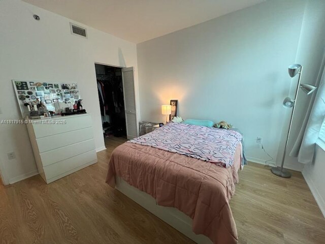 950 Brickell Bay Dr Unit 1608, Miami, FL 33131 - bedroom with light wood-type flooring and a closet