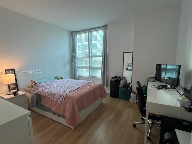 950 Brickell Bay Dr Unit 1608, Miami, FL 33131 - bedroom with light wood-type flooring and a desk