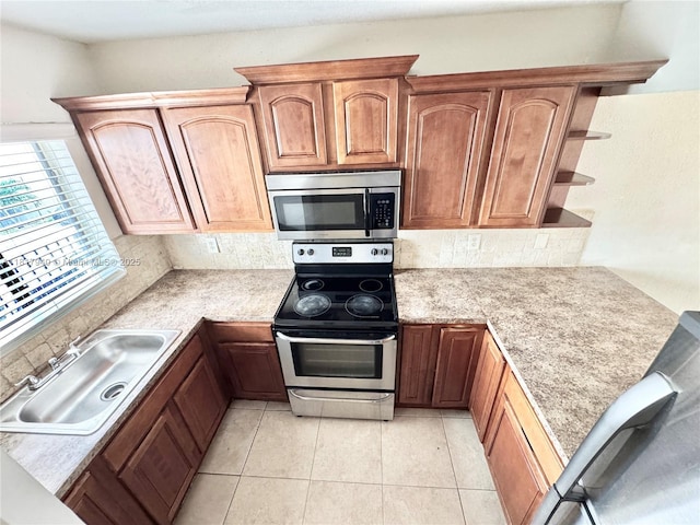 6121 W 24th Ave Unit 204, Hialeah, FL 33016 - kitchen featuring appliances with stainless steel finishes, a sink, light countertops, tasteful backsplash, and open shelves