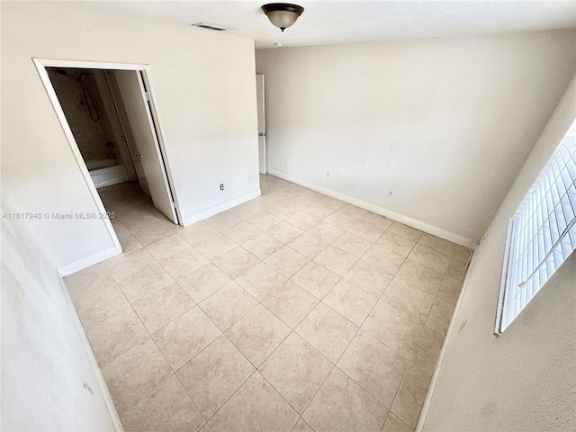 6121 W 24th Ave Unit 204, Hialeah, FL 33016 - unfurnished bedroom with light tile patterned flooring and baseboards