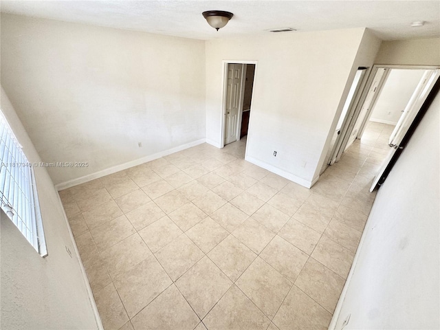 6121 W 24th Ave Unit 204, Hialeah, FL 33016 - spare room with light tile patterned flooring and baseboards