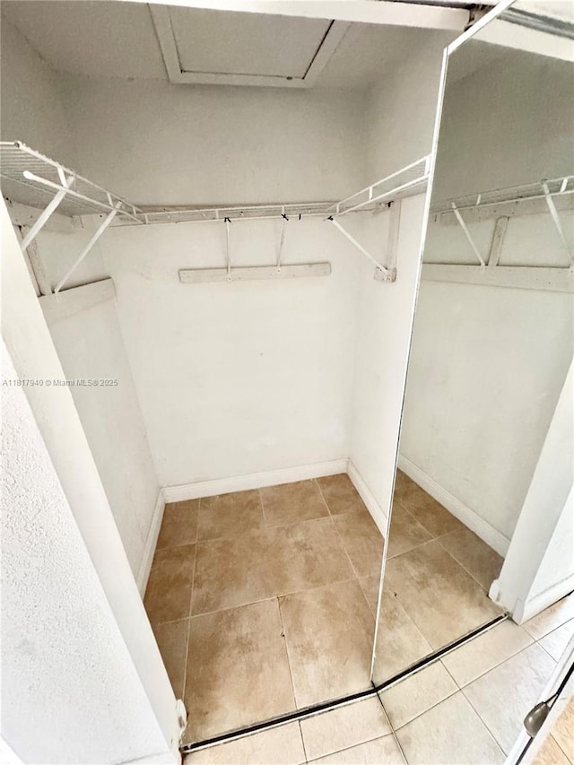 6121 W 24th Ave Unit 204, Hialeah, FL 33016 - walk in closet featuring tile patterned floors
