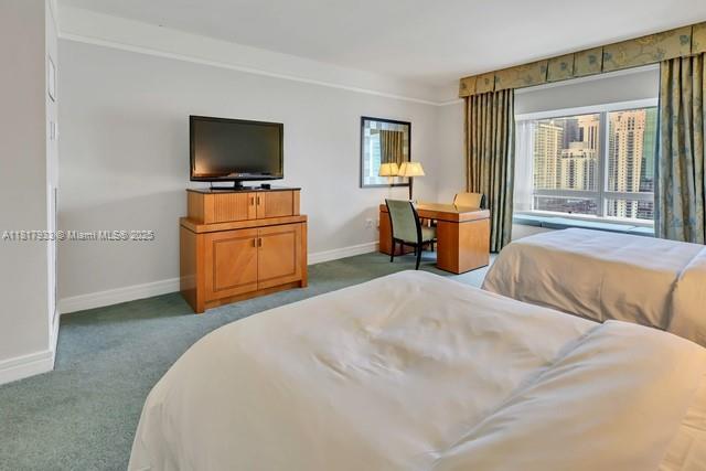 1435 Brickell Ave Unit 3011, Miami, FL 33131 - carpeted bedroom with baseboards and multiple windows