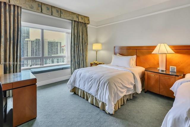 1435 Brickell Ave Unit 3011, Miami, FL 33131 - bedroom with carpet floors, baseboards, and crown molding