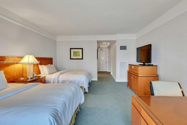 1435 Brickell Ave Unit 3011, Miami, FL 33131 - bedroom featuring carpet, ornamental molding, and baseboards