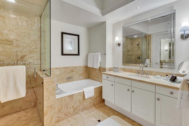 1435 Brickell Ave Unit 3011, Miami, FL 33131 - full bath featuring vanity, tiled shower, and a garden tub