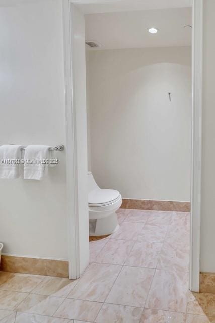 1435 Brickell Ave Unit 3011, Miami, FL 33131 - bathroom featuring toilet, tile patterned floors, and baseboards